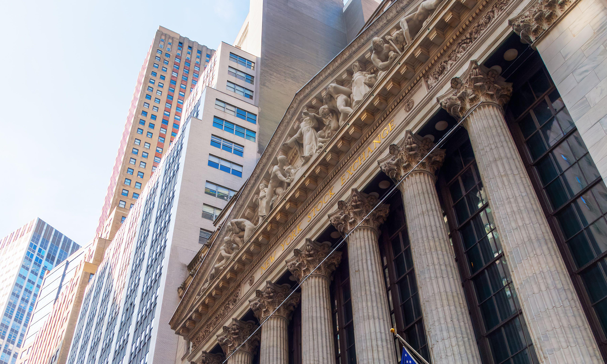 Image of buildings viewed from underneath with a closup of an older building with columns