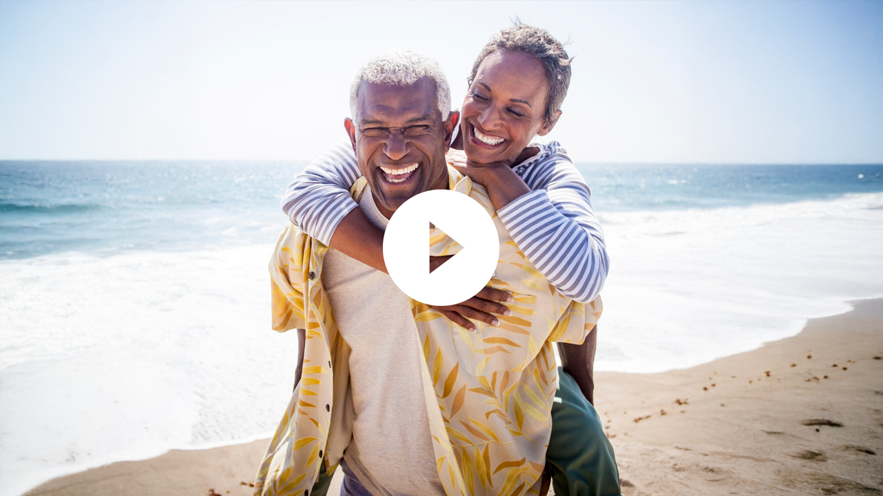A joyful family moment as a couple and their young daughter enjoy quality time together on the beach.