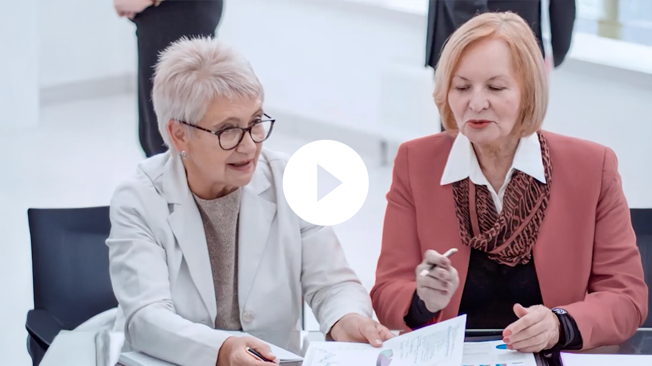 A professional businesswoman discusses health solutions with a doctor in a modern office setting, fostering collaboration.