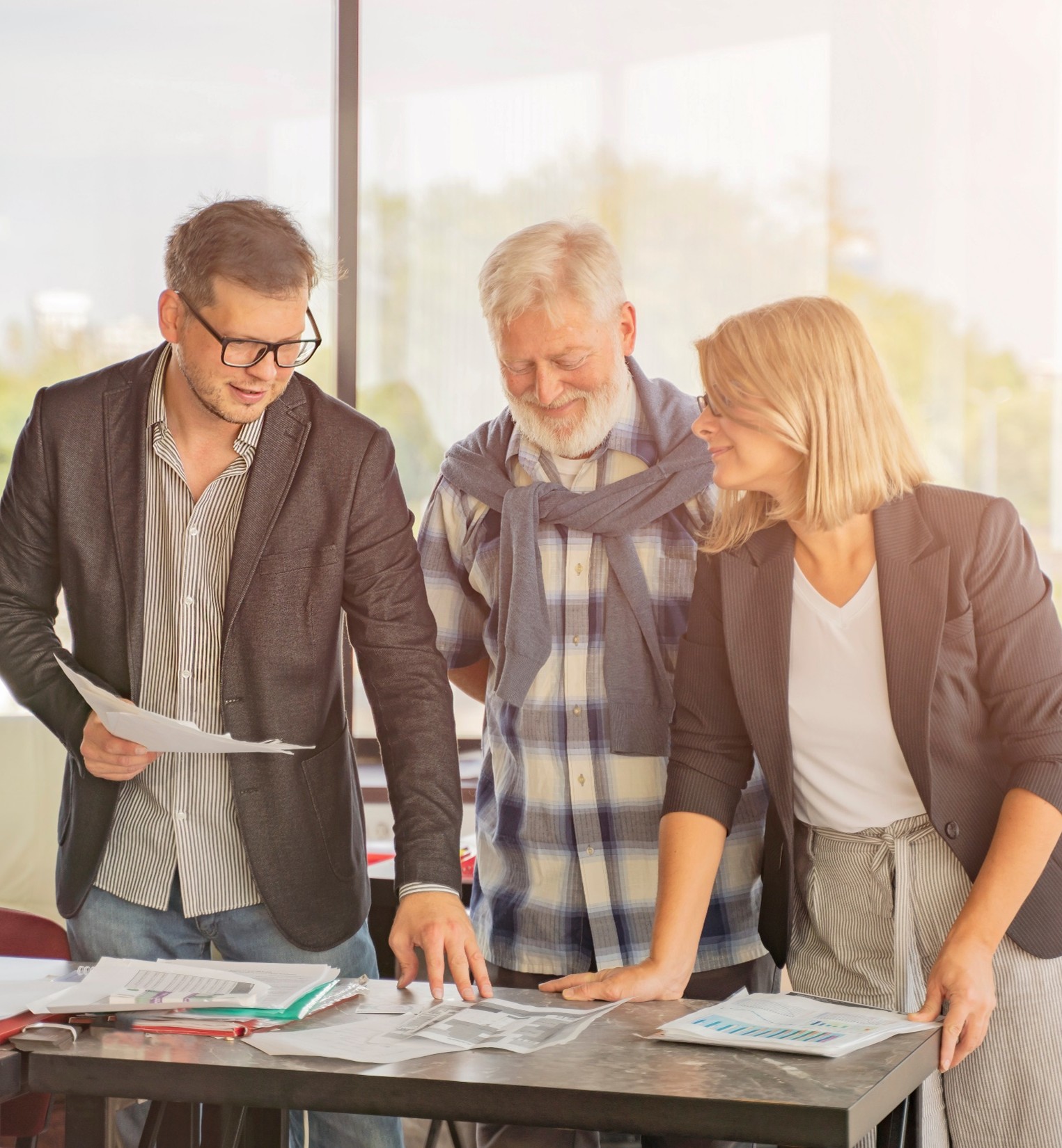 A senior couple discusses business plans at home, with the woman and man engaging in a professional conversation.