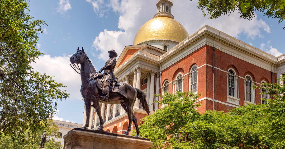 Landscape real estate photo of a historic colonial government courthouse beside a university campus in a downtown district.