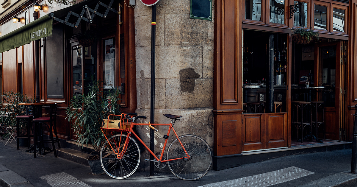 A classic bicycle rests on an old city street in Amsterdam, showcasing urban cycling as a timeless mode of transportation.