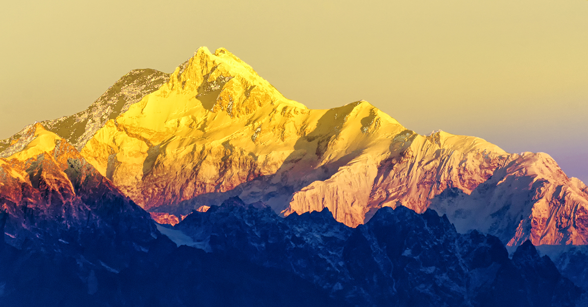 A breathtaking view of snow-capped mountains under a vibrant sunrise, showcasing the beauty of nature's serene landscape.