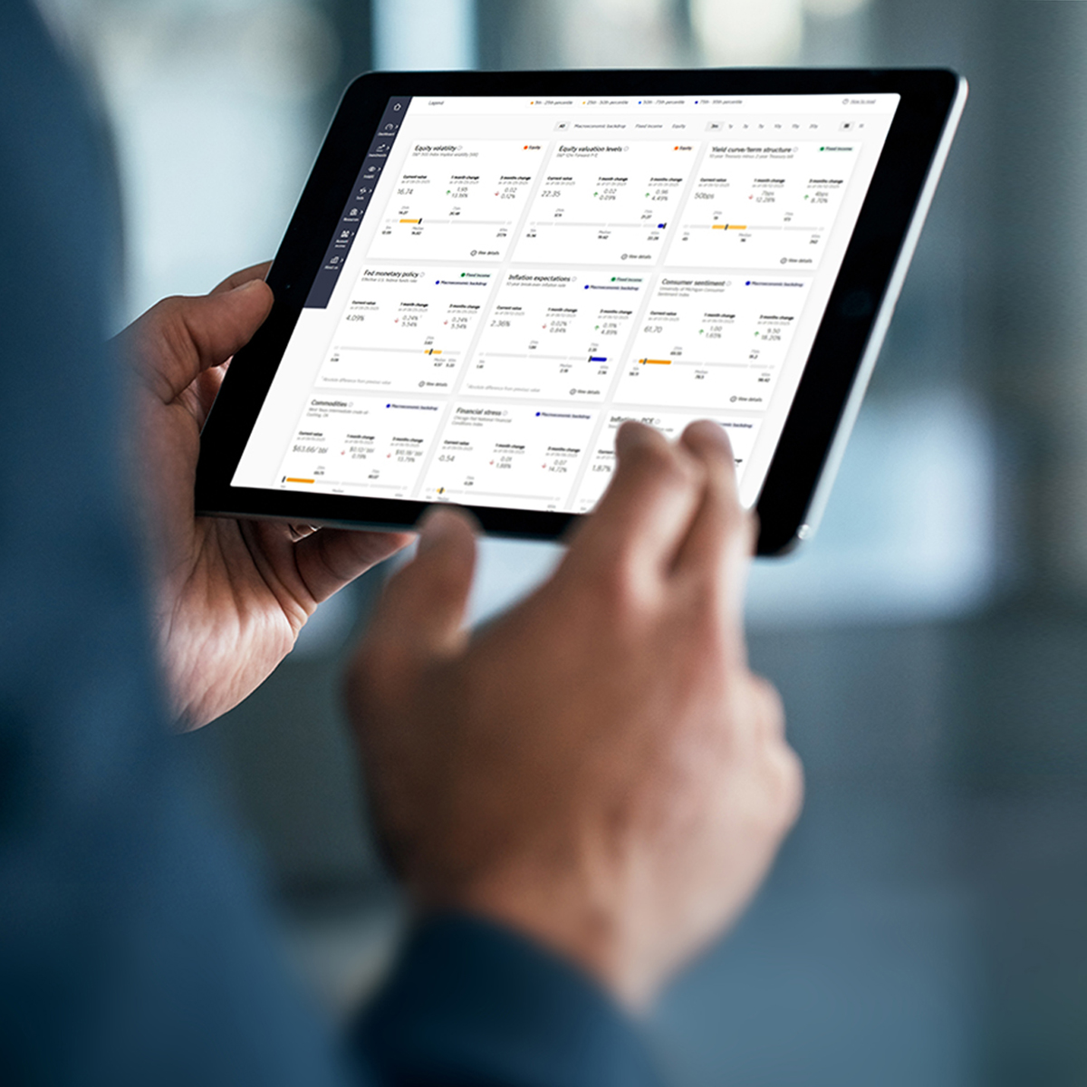 Business photo of a man using a touchscreen tablet and touchpad, viewing square aerospace engineering diagram with a client.