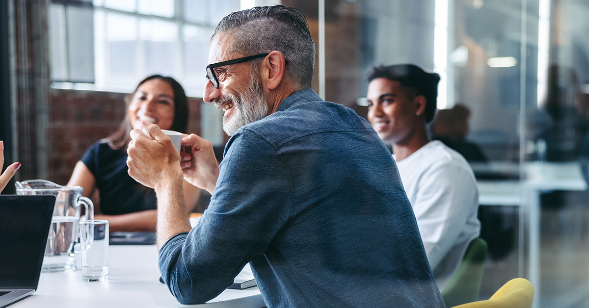 A group of professionals, including a young businesswoman and businessmen, collaborate in a positive and productive setting.