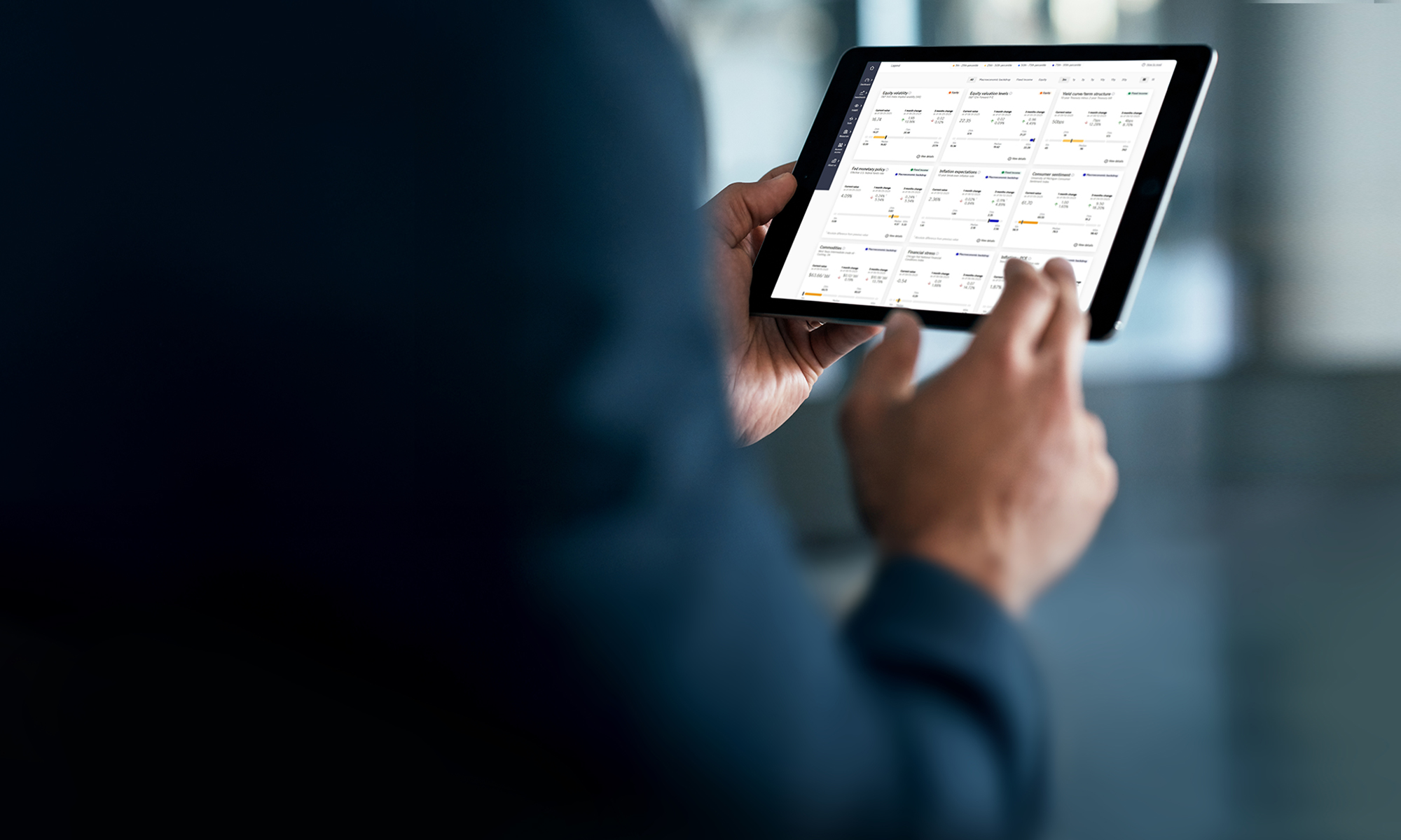 Person working at a table and looking at a lap top. 