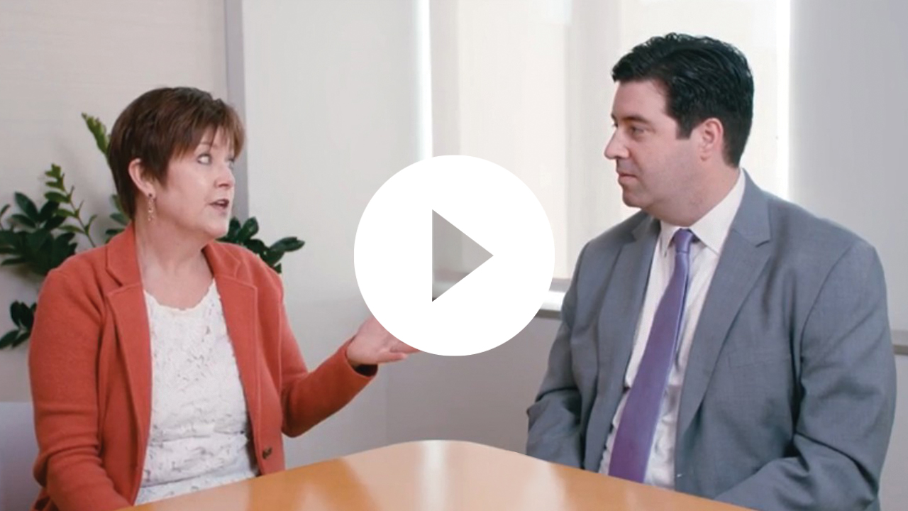 A young businesswoman and businessman engage in a professional discussion at the office, fostering collaboration and ideas.