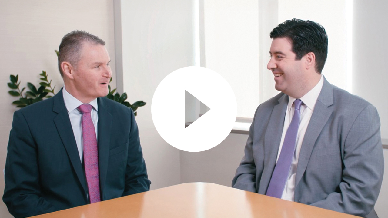 A professional businessman collaborates with colleagues during a meeting in a modern office environment.