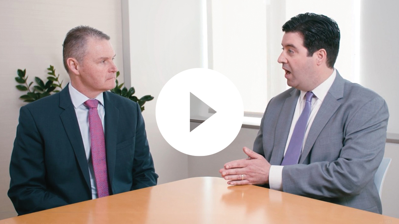 A group of business professionals engaged in a meeting, collaborating in a modern office environment.