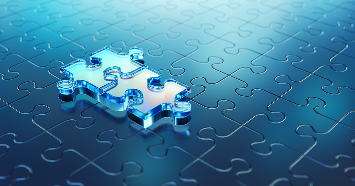 Two puzzle pieces on top of completed puzzle.