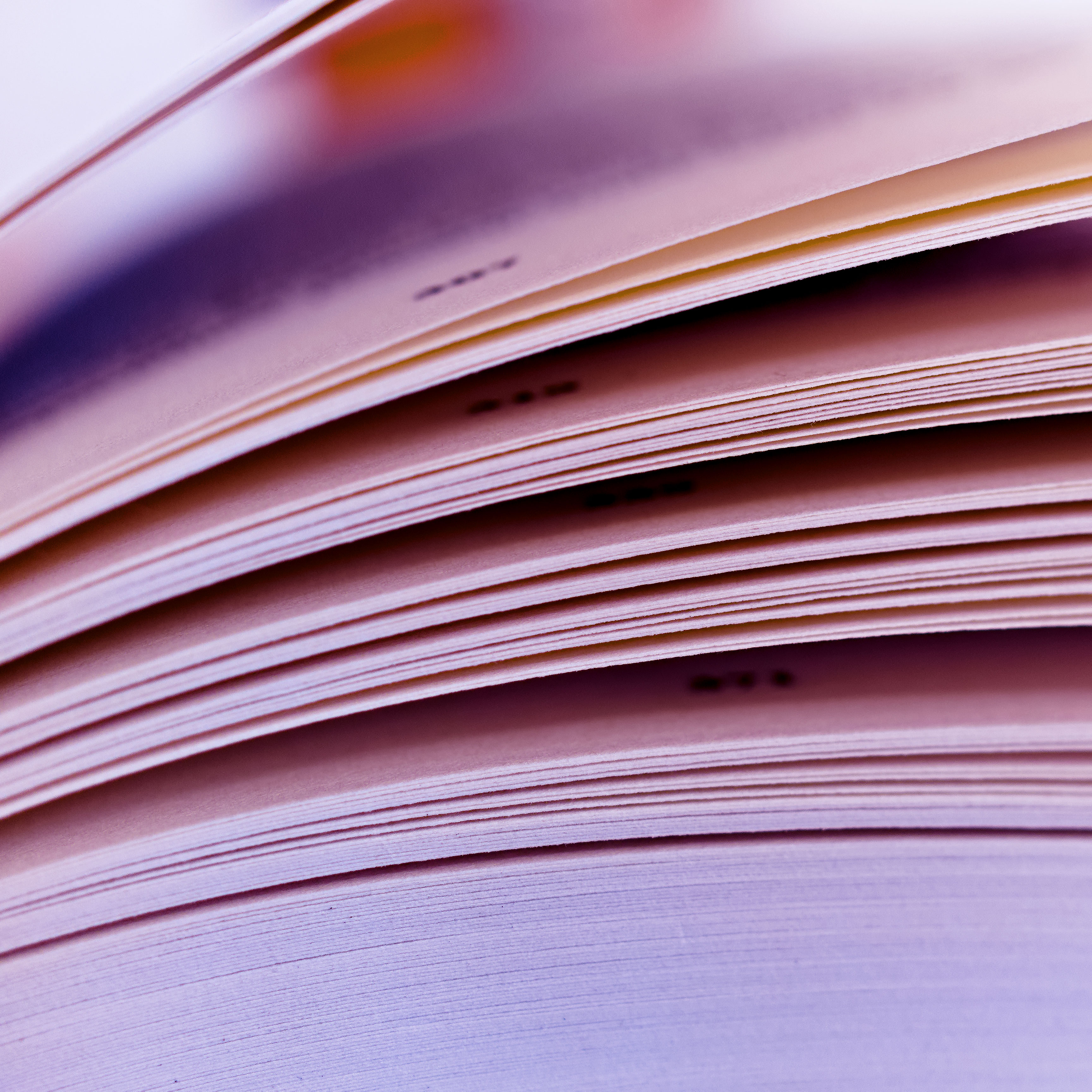 An abstract design of colorful books stacked in lines against a library backdrop, exuding a paper aesthetic.