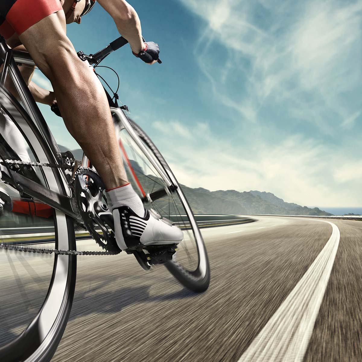 Experience the thrill of cycling on an adventurous road bike, under the vast blue sky, alongside the stunning sea.