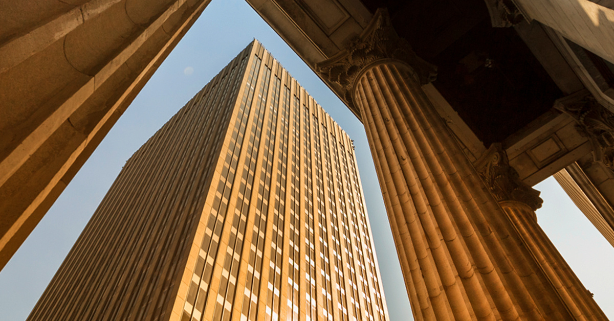 Will U.S. banking woes accelerate the shift to a fragmented global economy? Modern glass skyscrapers punctuate the urban city skyline, showcasing innovative business architecture.