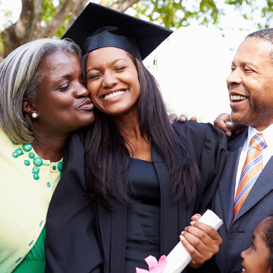 A young couple shares a joyful moment outdoors, celebrating the woman's graduation and their shared sense of accomplishment.